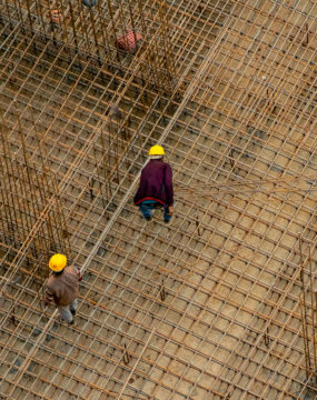Construction Workers In India Standing On A Rebar Reinforcing Bar Platform Making A Pillar